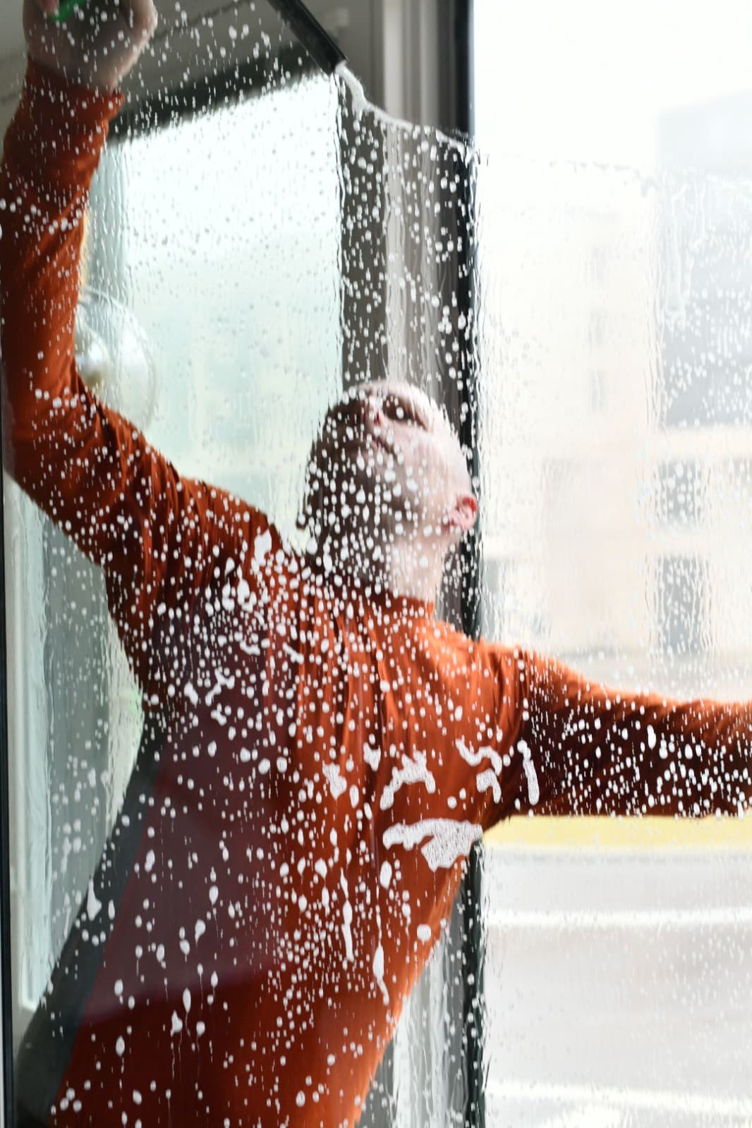 Professional window cleaner at work