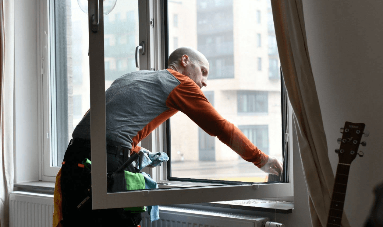 Professional window cleaner at work