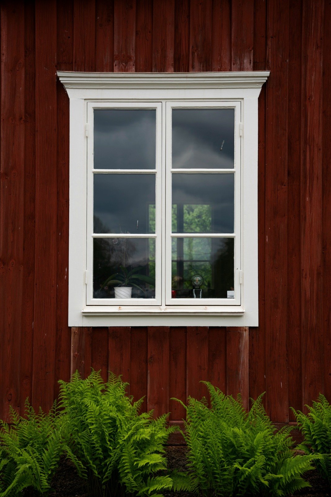 Tradesperson applying a careful finish to a wooden window frame